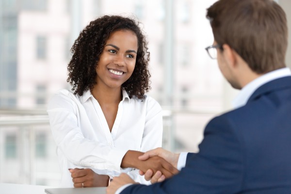 Woman and business man shaking hands